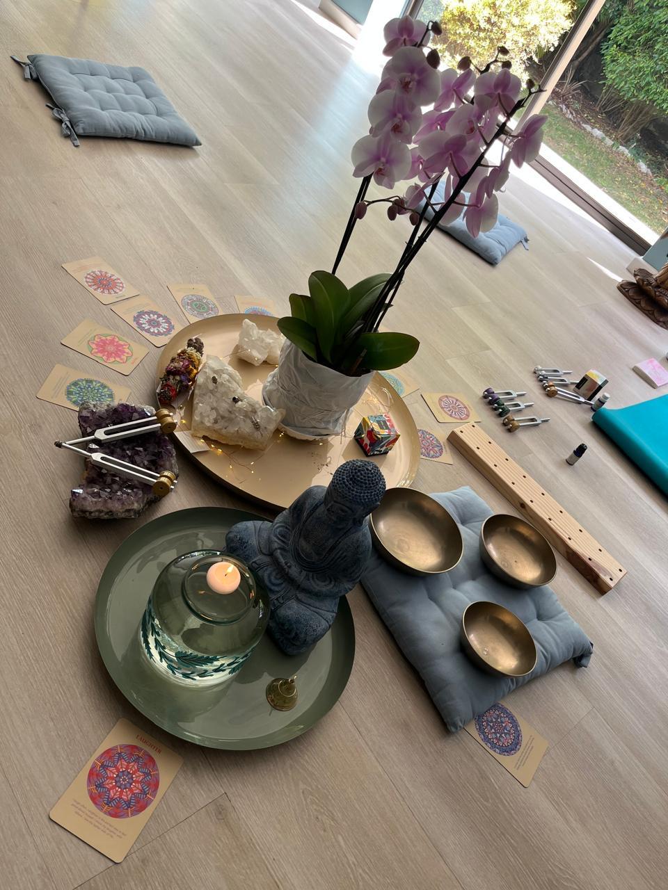 Sound healing altar with orchid, crystals, singing bowls and tuning forks