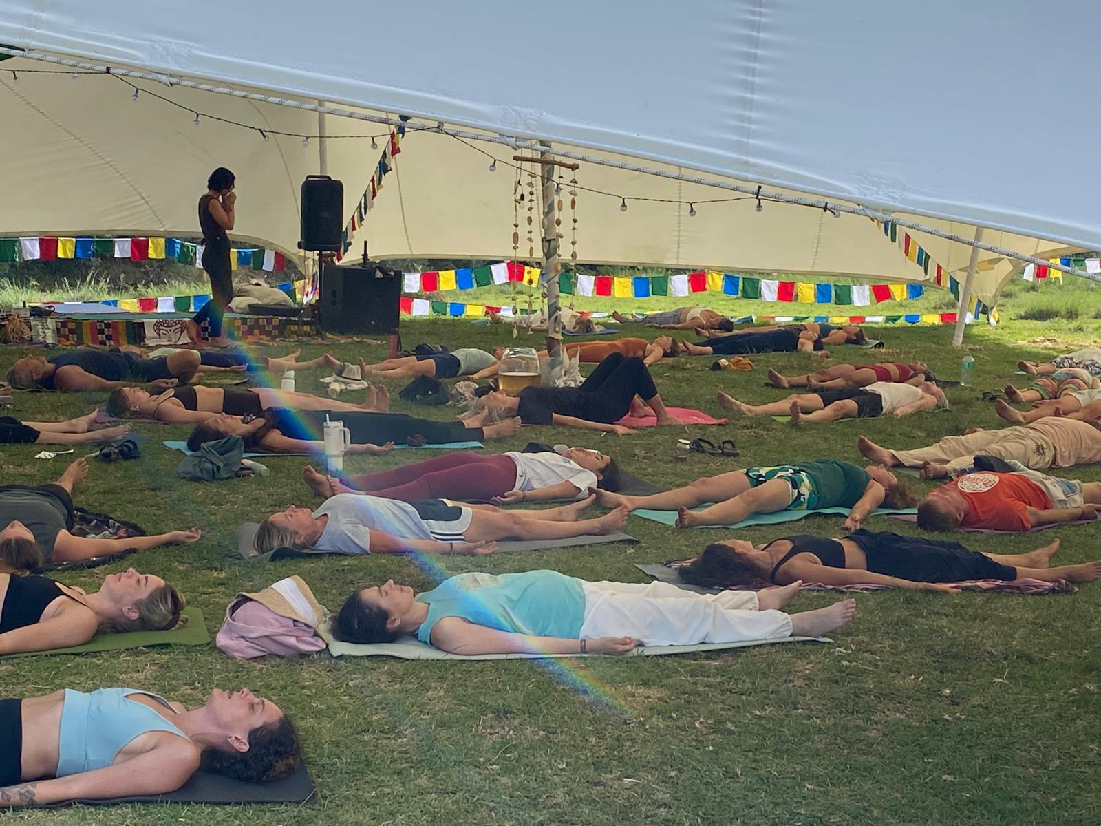 Deep relaxation in Shavasana under the festival tent