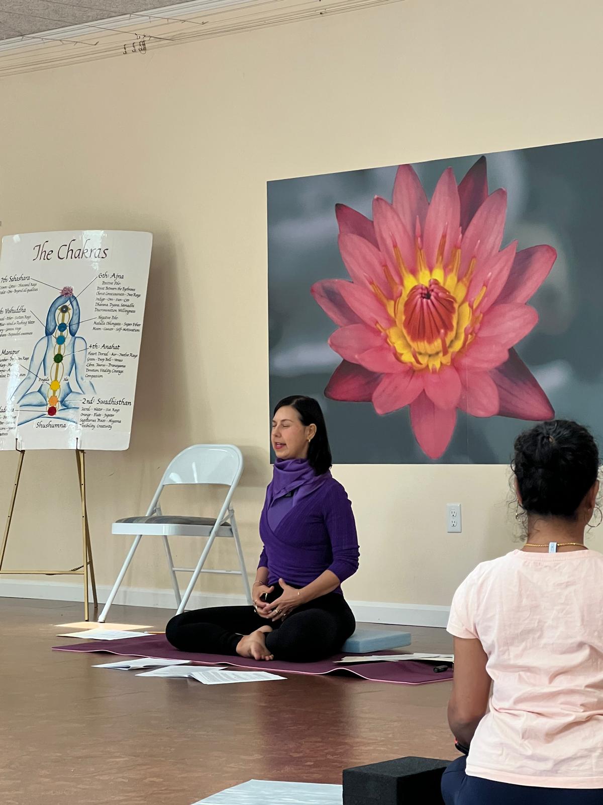 Amanda Lamprecht teaching beside a chakra chart
