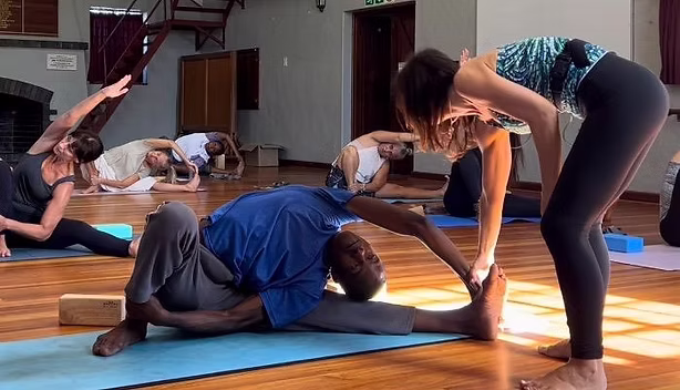 Group yoga teacher training class practicing asanas